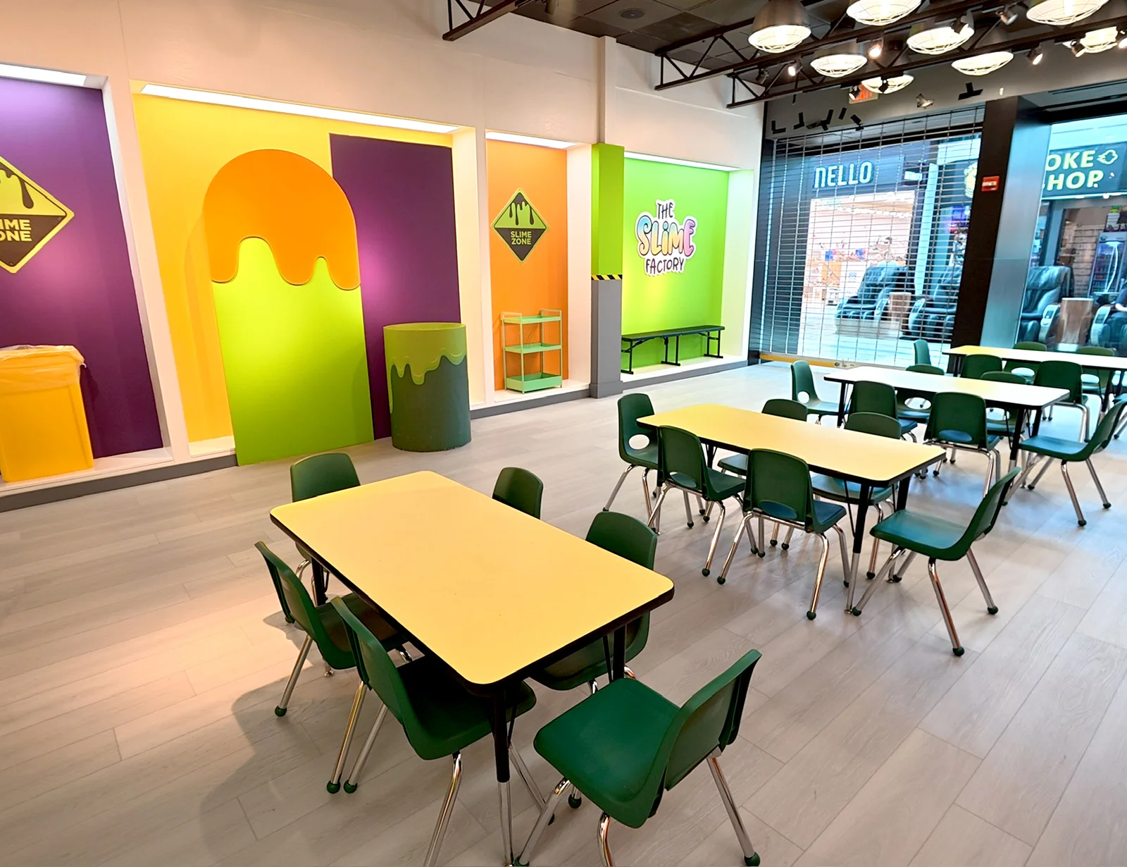 Pembroke Pines’ large party area with rectangular yellow tables and green chairs.