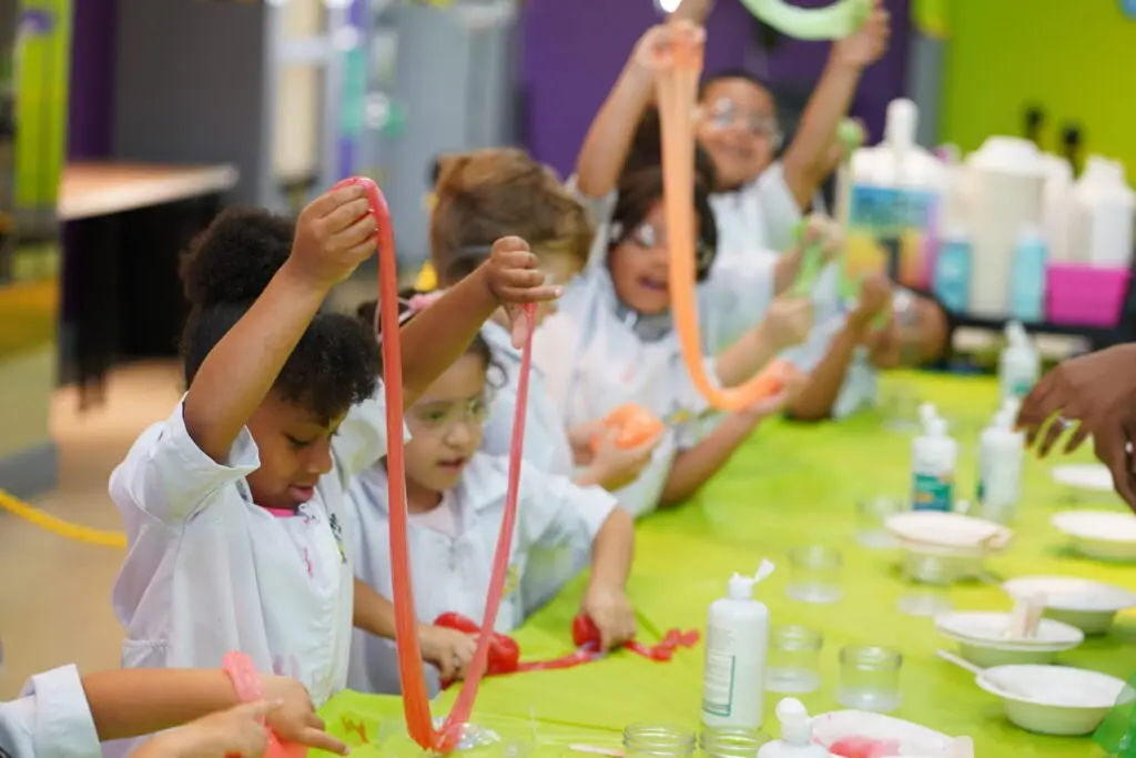 Students gathered around tables making slime during a field trip